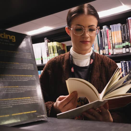 MA Dance Research 1080 Dance student reading book in library