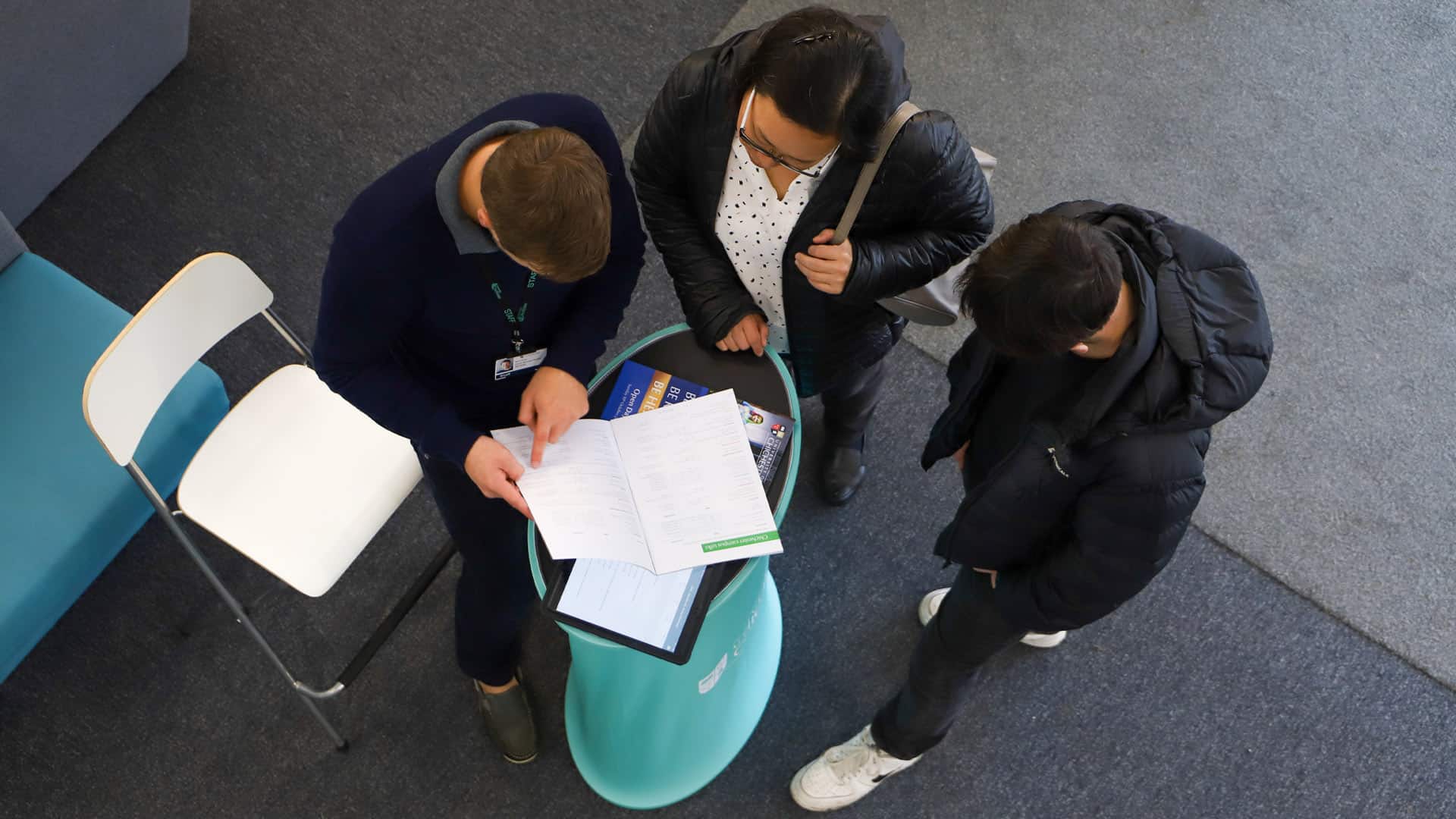 Visitors and a staff member talking at an open event