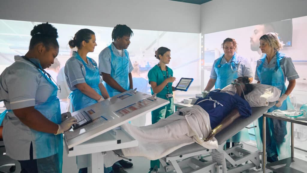 Nursing students having a lesson in the immersive simulation room